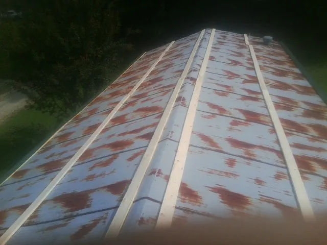 Rusted metal roof panels with new wood purlins before replacement — Storm Damage Roof Repair in Denmark by Roofing Brothers